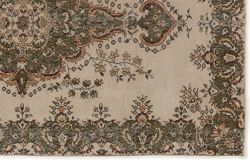 Load image 1 in gallery view. Beige rug with a traditional olive green and rust-colored floral medallion pattern and ornate border.