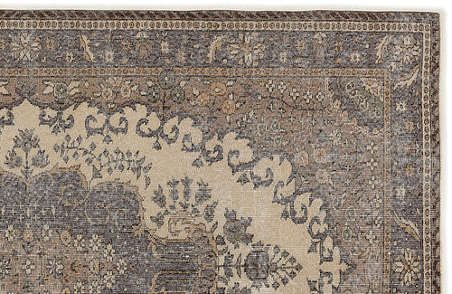 Load image 1 in gallery view. Dark brown and beige rug with a traditional distressed floral medallion pattern and a detailed border.