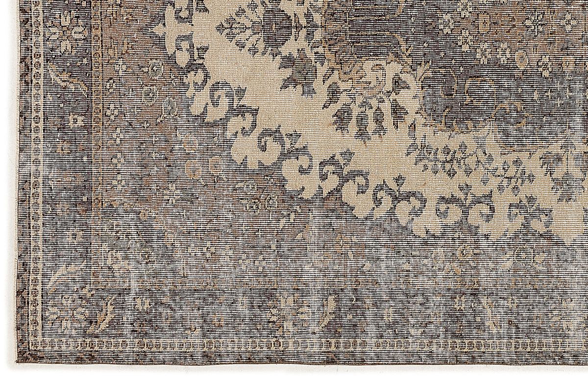 Charcoal and beige rug with a distressed traditional medallion pattern and a detailed border.
