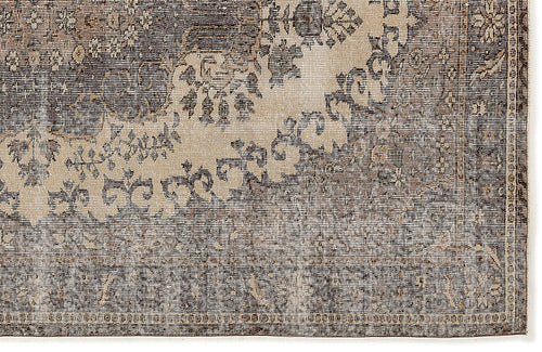 Load image 1 in gallery view. Charcoal and beige rug with a distressed, traditional floral medallion pattern and a linear textured weave.
