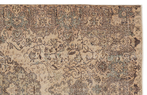 Load image 1 in gallery view. Distressed beige and brown rug with a faded traditional floral medallion pattern.