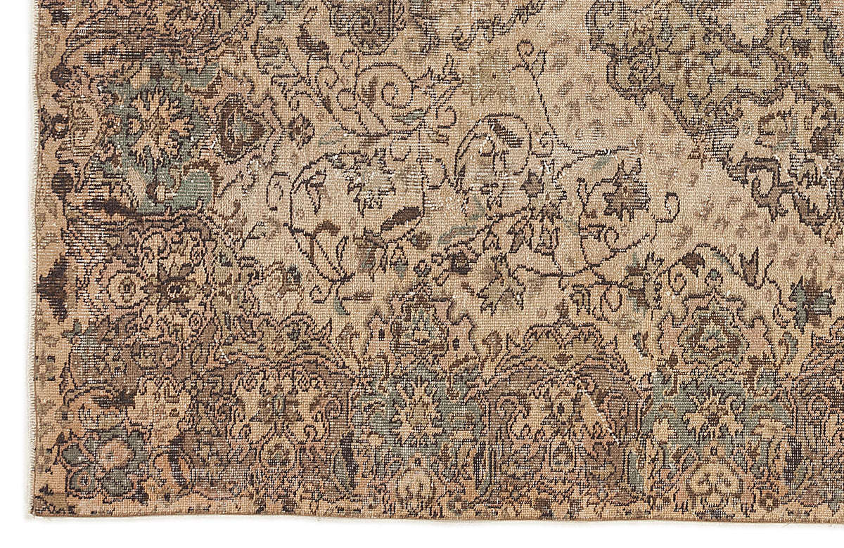 Distressed beige, brown, and sage green rug with a traditional floral medallion pattern.