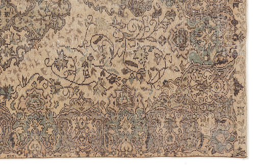Load image 1 in gallery view. Beige, brown, and muted green distressed rug with an intricate, faded traditional floral pattern.
