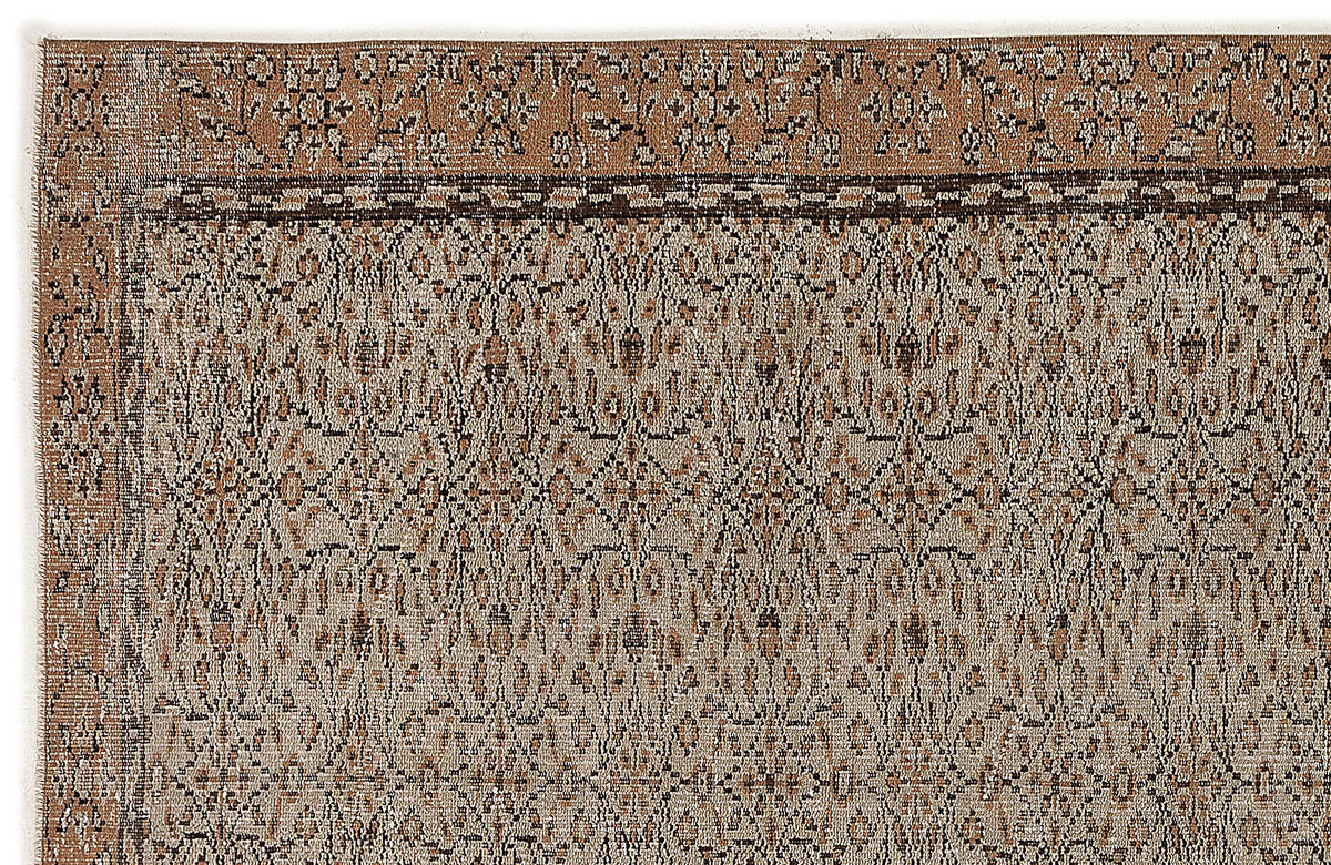 Brown and beige rug with a distressed, intricate floral medallion pattern and a decorative border.