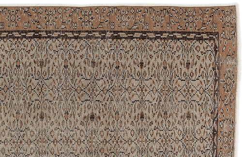 Load image 1 in gallery view. Tan and dark brown rug with a traditional floral border and a repeating geometric medallion pattern.