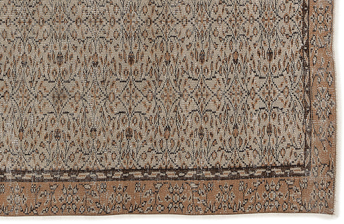 Load image 1 in gallery view. Tan and brown rug with a dense, distressed geometric pattern and a wide decorative border.