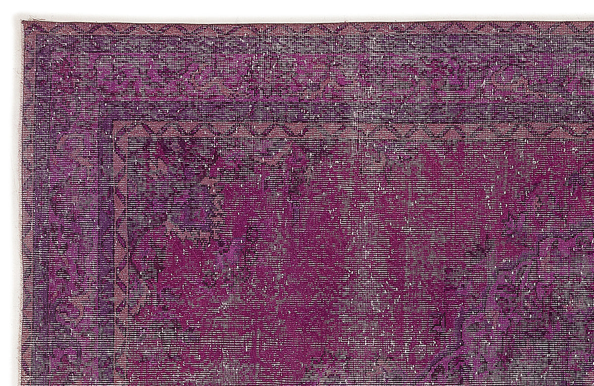 Deep purple distressed rug with a traditional border and faded medallion pattern on a white background.