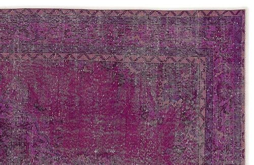 Load image 1 in gallery view. Deep purple distressed rug with a geometric border and faded, worn-in texture.
