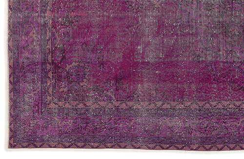 Load image 1 in gallery view. Deep purple vintage-style rug with a distressed floral medallion pattern and a geometric border.