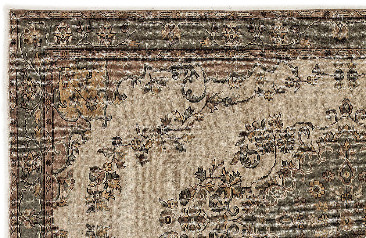 Beige, sage green, and brown traditional rug with a floral border and central medallion pattern.