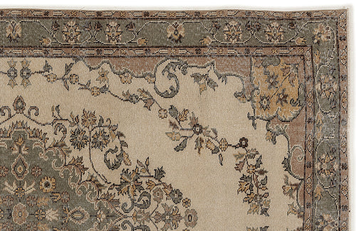 Load image 1 in gallery view. Beige, sage green, and brown traditional rug with a floral medallion and vine border pattern on a white background.