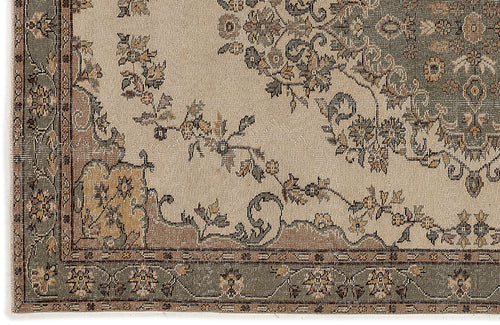 Load image 1 in gallery view. Beige rug with a sage green and brown traditional floral medallion pattern and a decorative border.