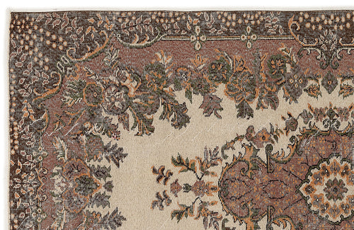 Load image 1 in gallery view. Close-up of a traditional rug with a beige field, featuring brown, green, and orange floral and medallion motifs.