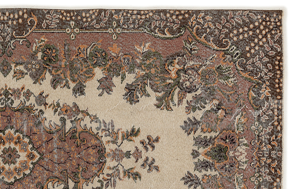 Traditional rug with a cream field and a dark brown border featuring intricate floral and vine motifs in green and orange.