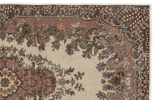 Load image 1 in gallery view. Traditional rug with a cream field and a dark brown border featuring intricate floral and vine motifs in green and orange.