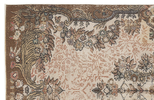 Load image 1 in gallery view. Brown and cream traditional rug with a distressed floral medallion pattern and ornate border.