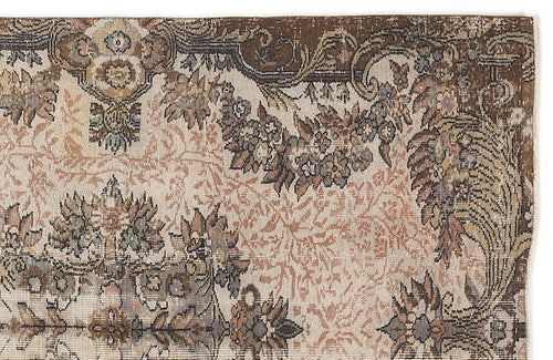 Load image 1 in gallery view. Distressed vintage-style rug with a brown, cream, and muted floral medallion pattern on a white background.