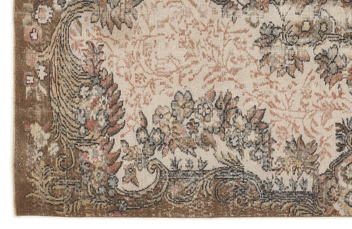 Load image 1 in gallery view. Beige and brown traditional rug with a distressed floral medallion pattern and ornate border.