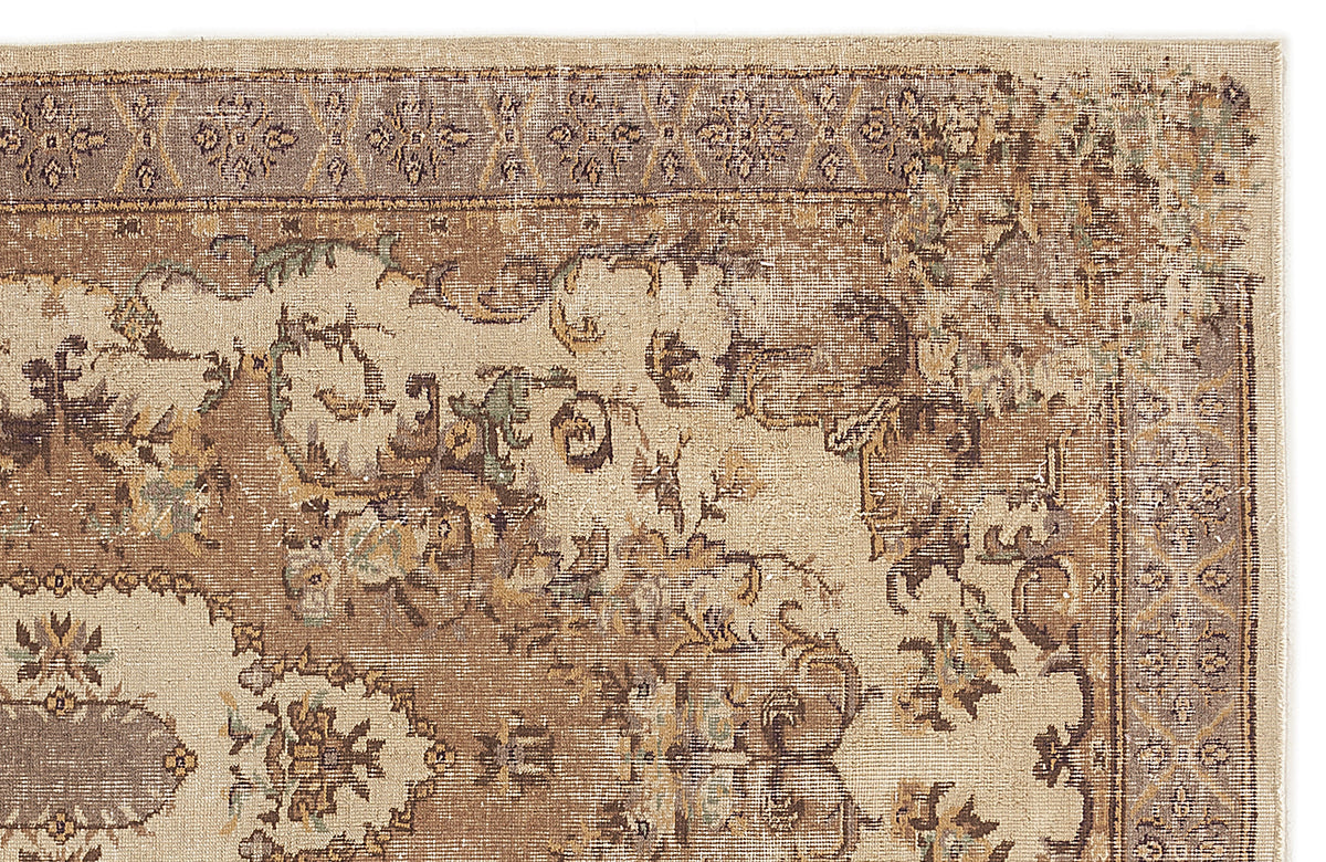 Beige and brown traditional rug with a distressed floral medallion pattern and a decorative border.