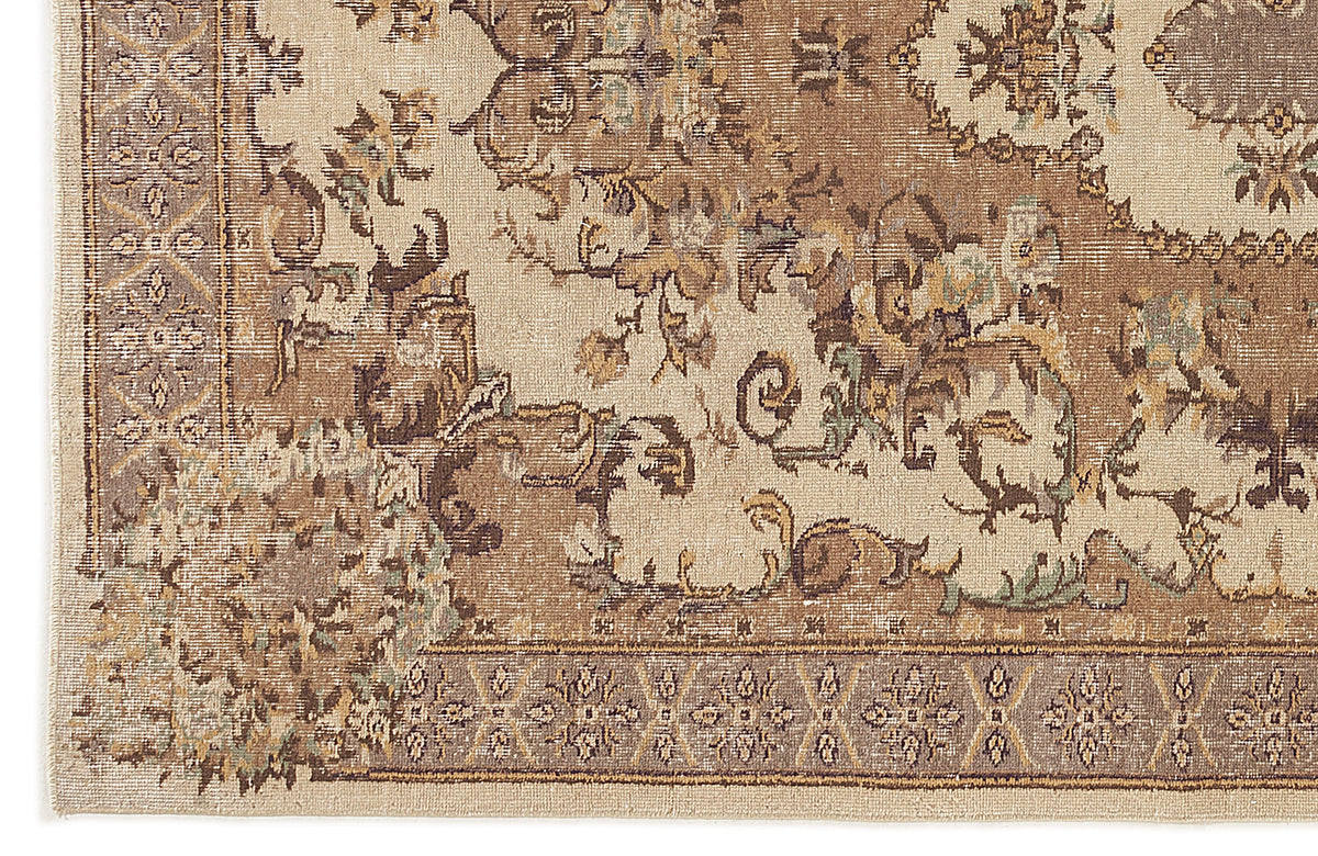 Beige and brown traditional rug with a distressed floral medallion pattern and a geometric border.