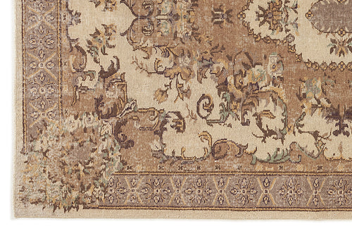 Load image 1 in gallery view. Beige and brown traditional rug with a distressed floral medallion pattern and a geometric border.