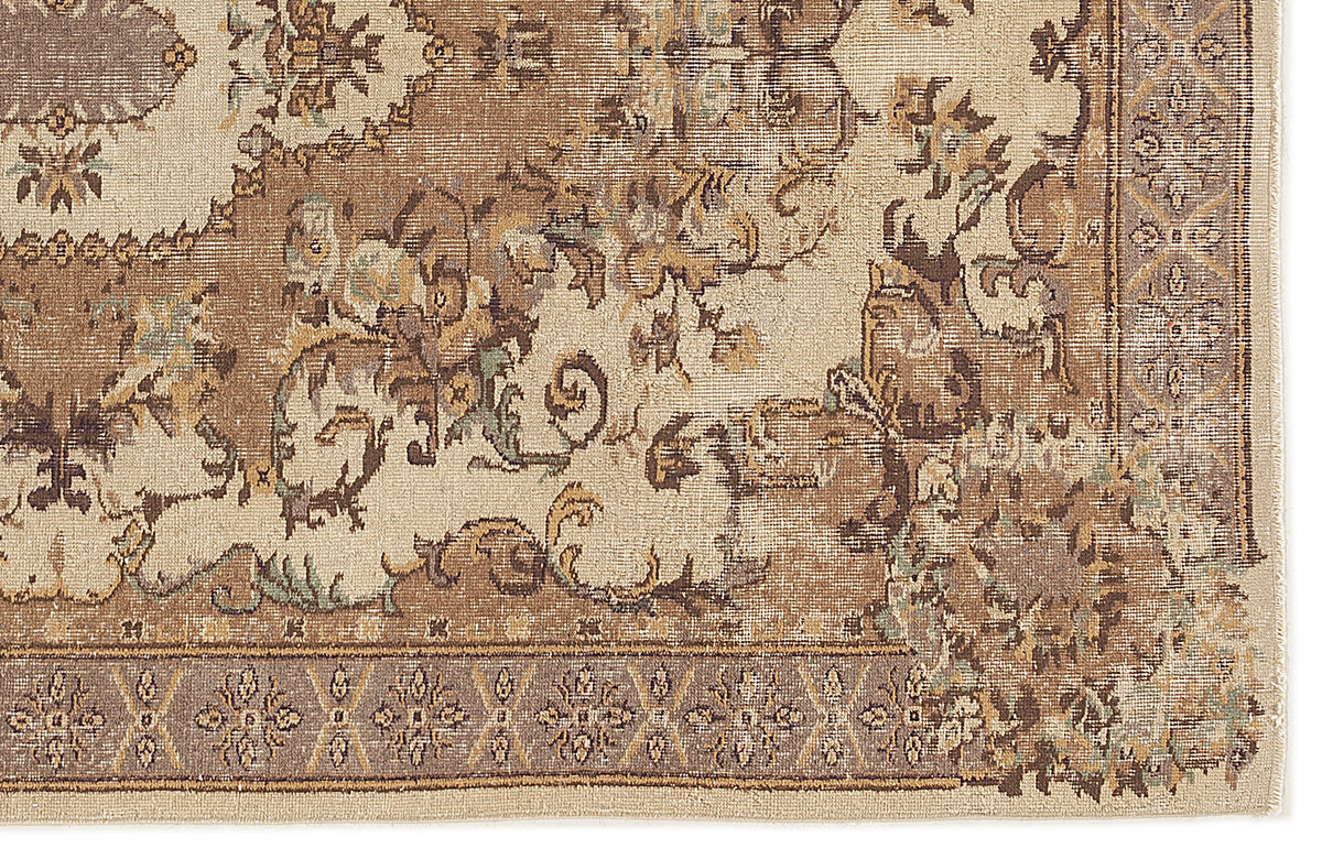 Beige and brown traditional rug with a distressed floral medallion pattern and a geometric border.