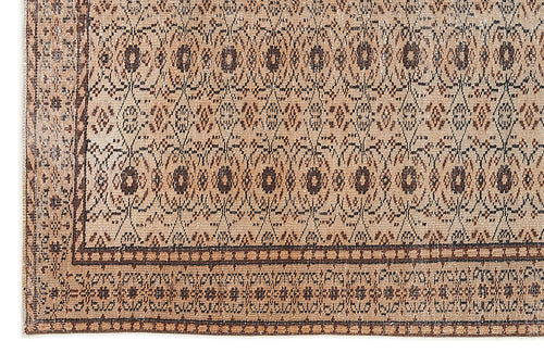 Load image 1 in gallery view. Tan and dark brown rug with a repeating geometric diamond pattern and a decorative border.