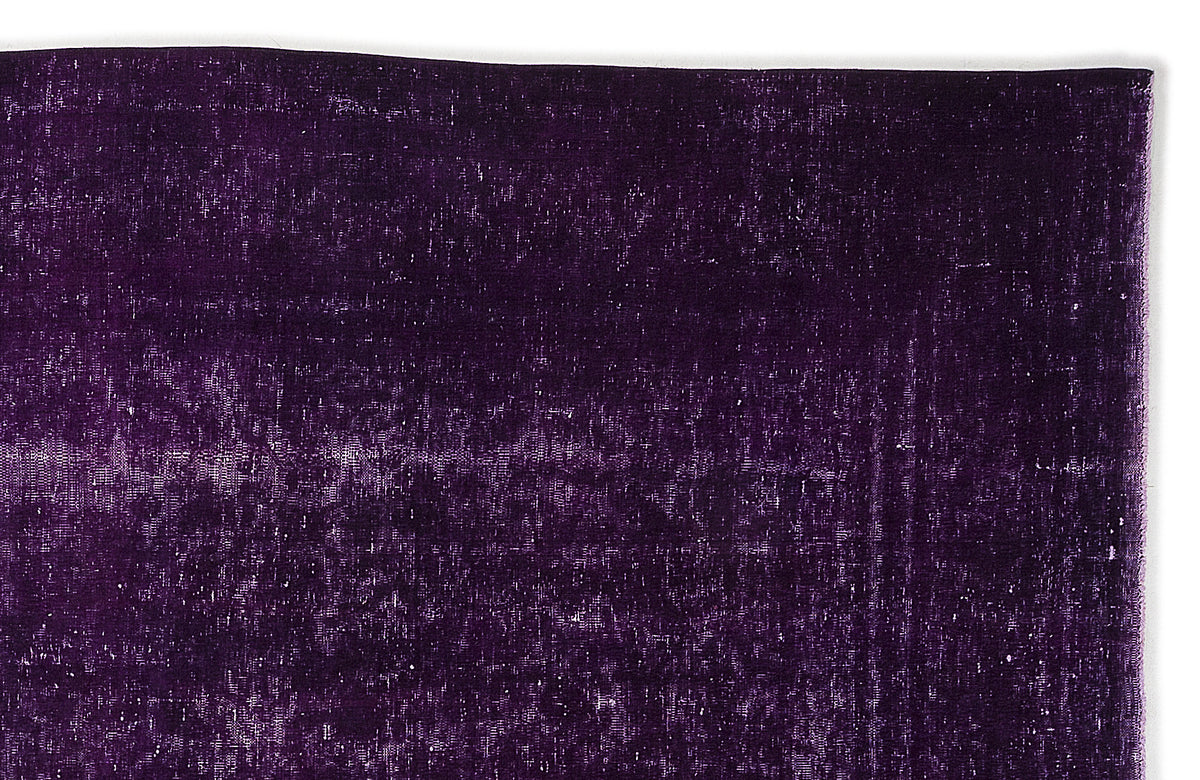 Deep purple overdyed vintage rug with a distressed, textured finish.