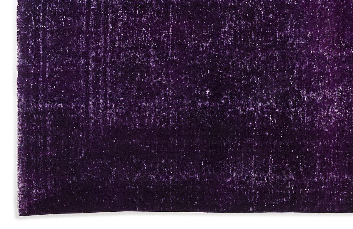 Deep purple vintage-style rug with a distressed, monochromatic texture.