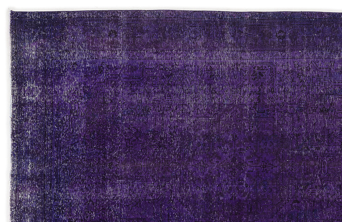 Deep purple vintage-style rug with a faint, distressed traditional medallion pattern.