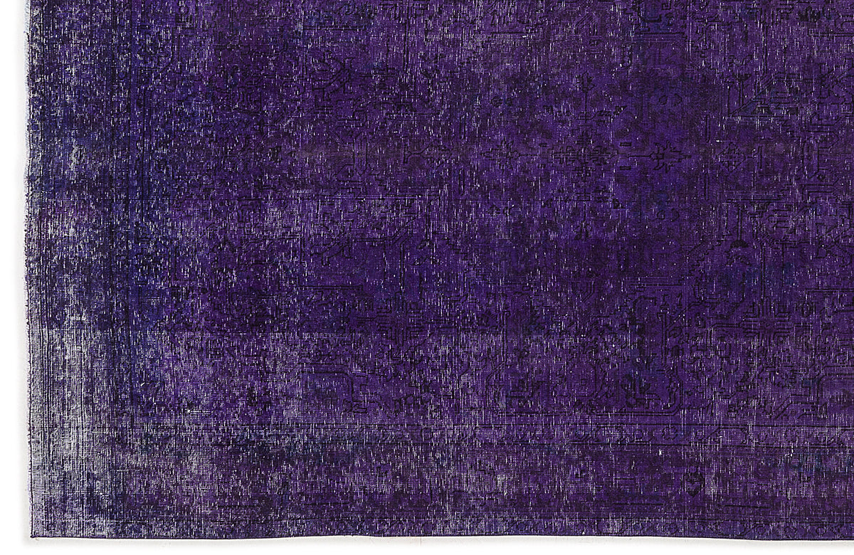 Deep purple overdyed rug with a faint, distressed traditional medallion pattern.