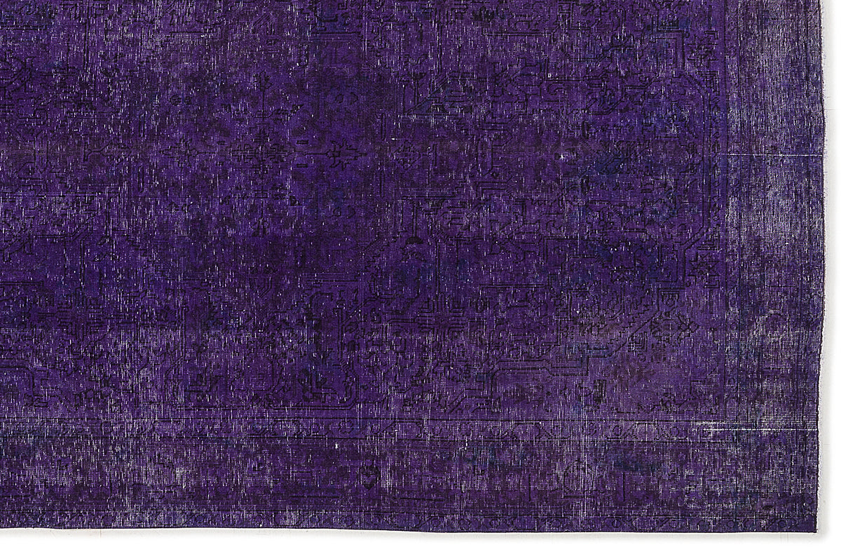 Deep purple vintage-style rug with a faint, distressed traditional medallion pattern and a bordered edge.
