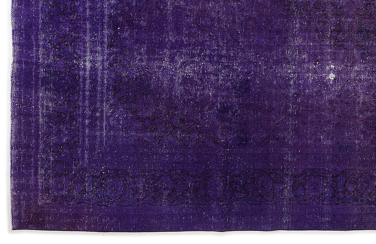 Deep purple vintage-style rug with a distressed, faded traditional border pattern.