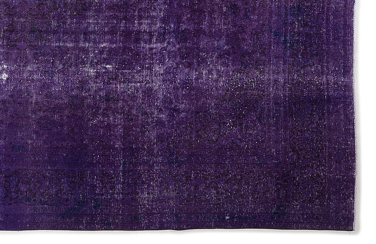 Deep purple vintage-style rug with a distressed, faded traditional medallion pattern on a white background.