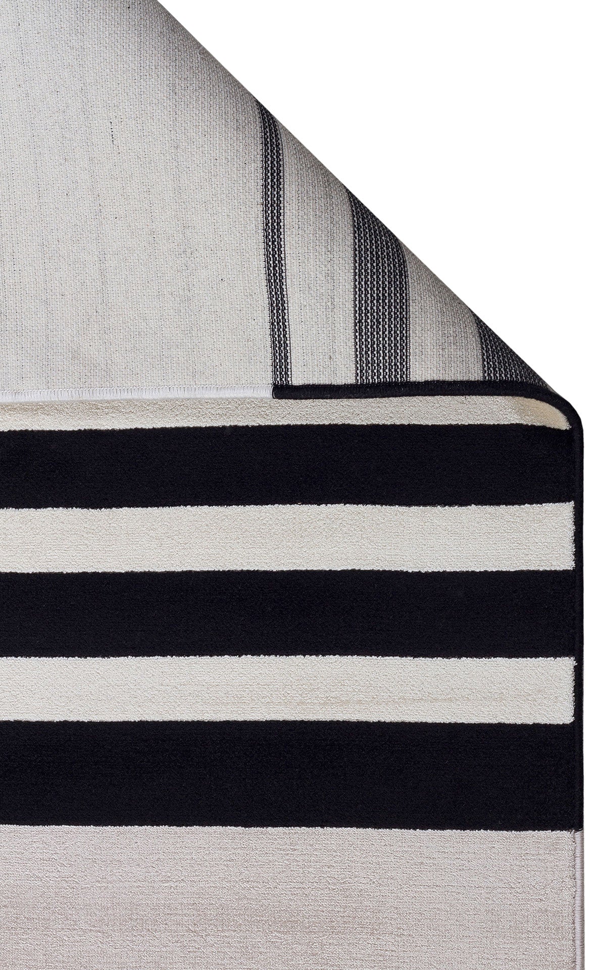 Black and white striped rug with a folded corner revealing the textured backing.