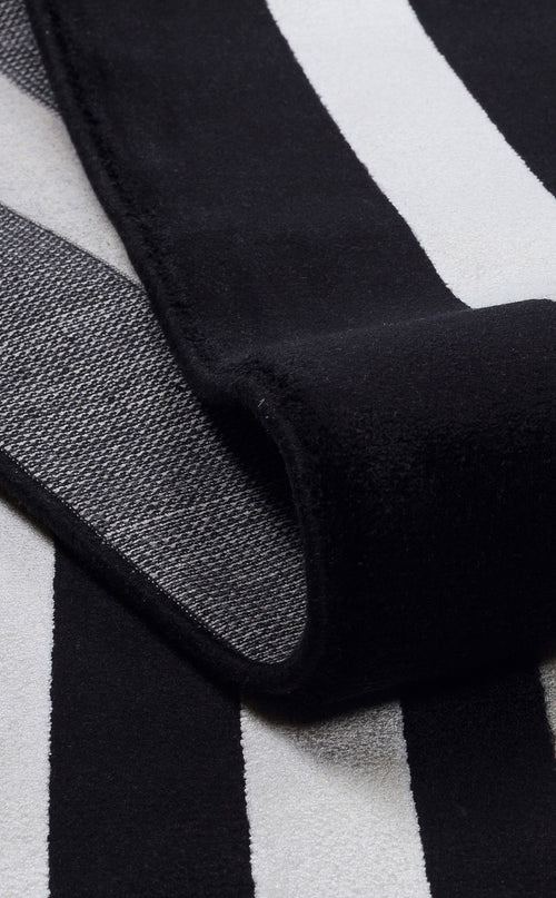 Bild 1 in Galerieansicht laden. Black and white striped rug with a folded corner showing a textured, woven backing.