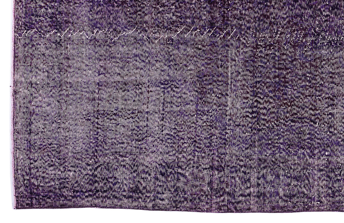 Deep purple vintage-style rug with a distressed, faded texture and subtle white linear detailing.