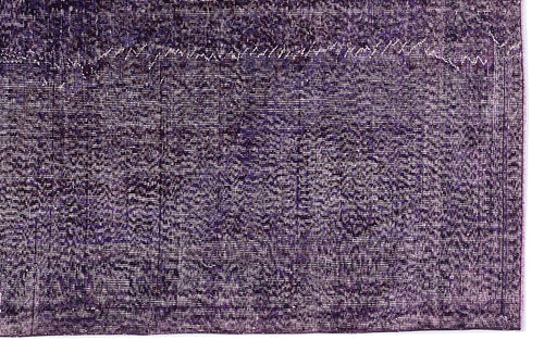 Load image 1 in gallery view. Deep purple distressed rug with a faded, traditional overdyed pattern and a visible border.