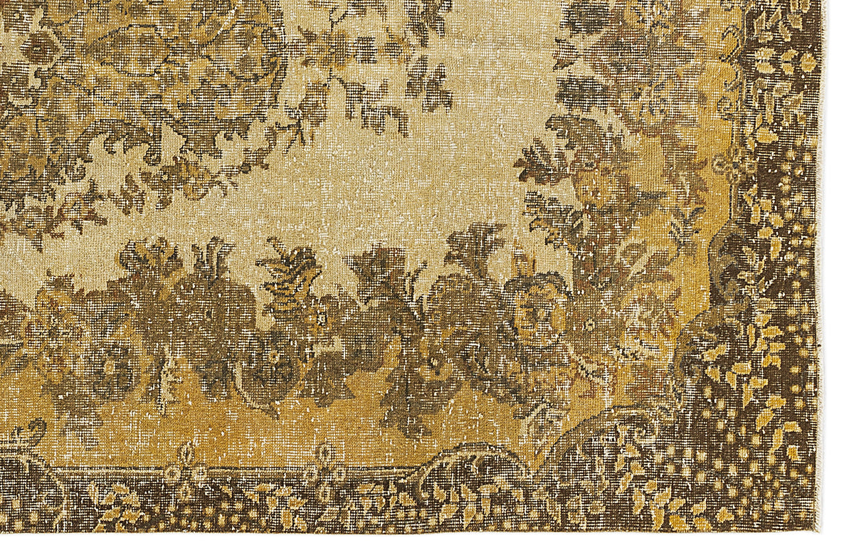 Distressed mustard yellow and dark brown rug with a traditional floral medallion pattern on a cream background.