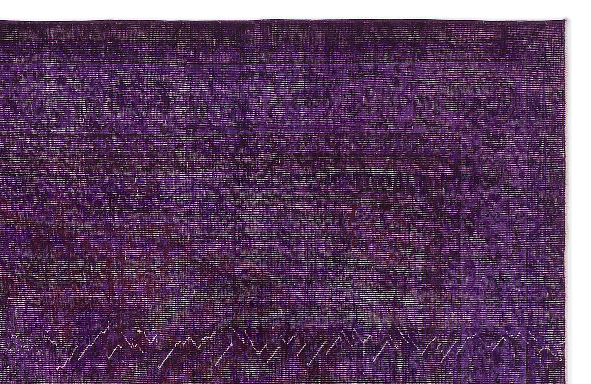 Deep purple vintage-style rug with a faint, distressed traditional medallion pattern on a white background.