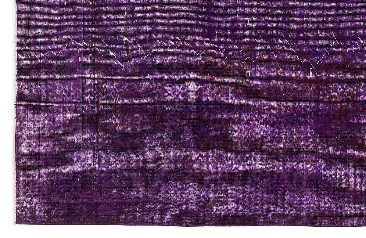 Deep purple vintage-style rug with a distressed, faded traditional medallion pattern and a geometric border.