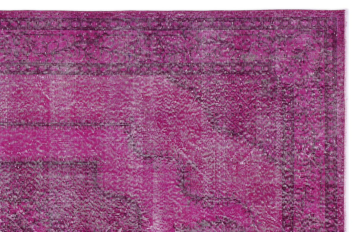 Magenta and dark purple distressed vintage-style rug with a traditional border and faded medallion pattern.