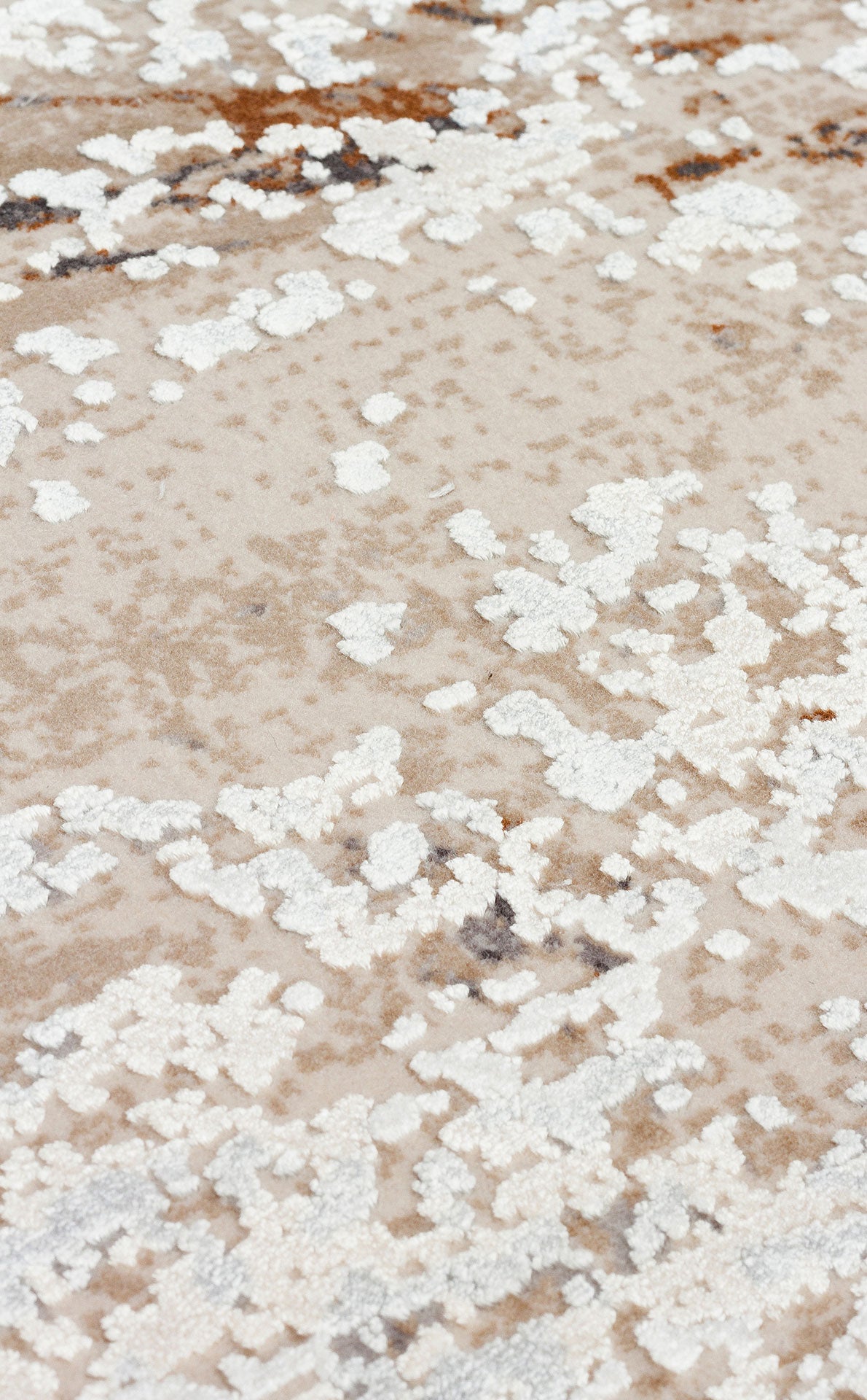 Beige and cream rug with a high-low pile, featuring an abstract distressed pattern with subtle brown and grey accents.
