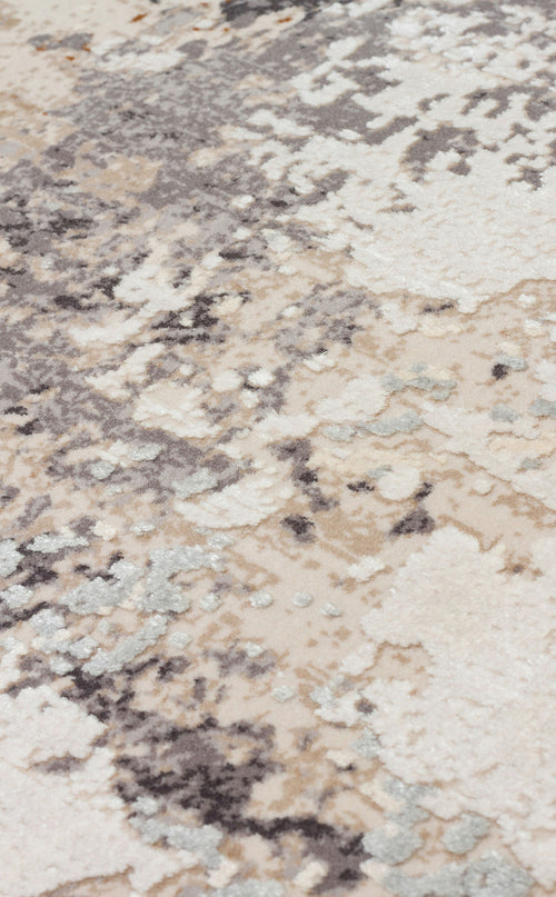 Bild 1 in Galerieansicht laden. Close-up of a rug with an abstract, distressed pattern in shades of cream, grey, and light blue.