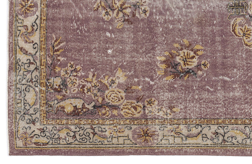 Load image 1 in gallery view. Distressed mauve rug with a beige border, featuring a floral pattern and geometric Greek key accents.