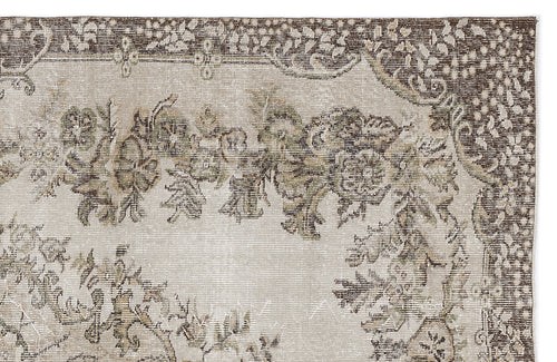 Load image 1 in gallery view. Beige and brown vintage-style rug with a distressed floral medallion pattern and a dark decorative border.
