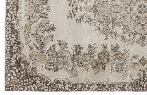 Load image 1 in gallery view. Beige and brown distressed rug with a traditional floral medallion pattern and ornate border.