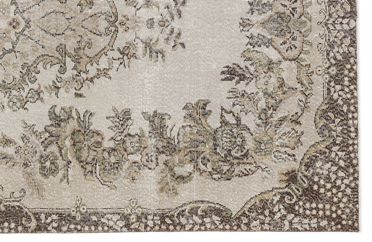 Beige and brown distressed rug with a traditional floral medallion pattern and ornate border.