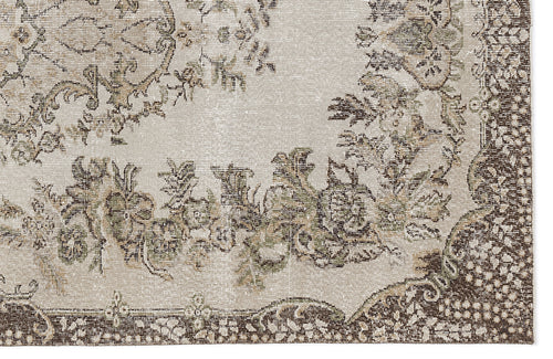 Load image 1 in gallery view. Beige and brown distressed rug with a traditional floral medallion pattern and ornate border.