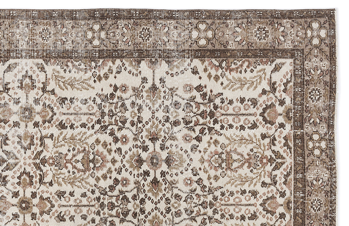 Cream, brown, and muted pink traditional rug with a distressed floral medallion pattern and a detailed border.